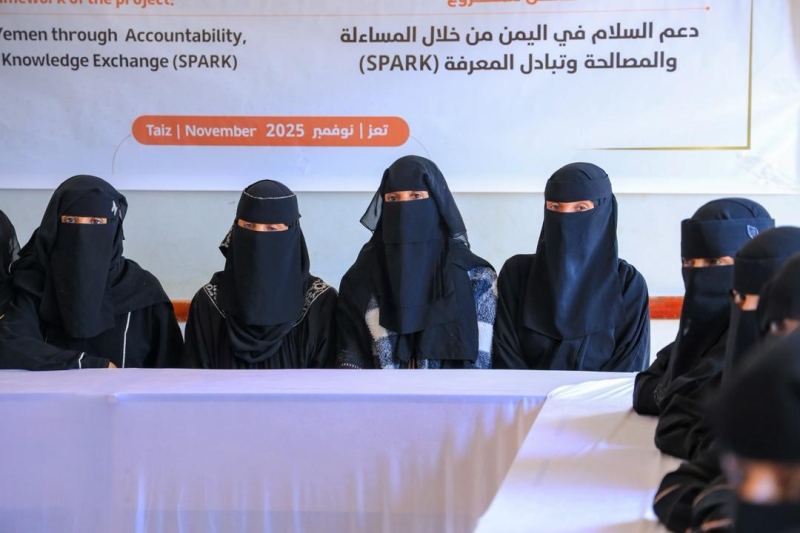 A group of women wearing black niqabs sit during a psychological support session under a restorative justice initiative for abductees’ families in Taiz, Yemen. 